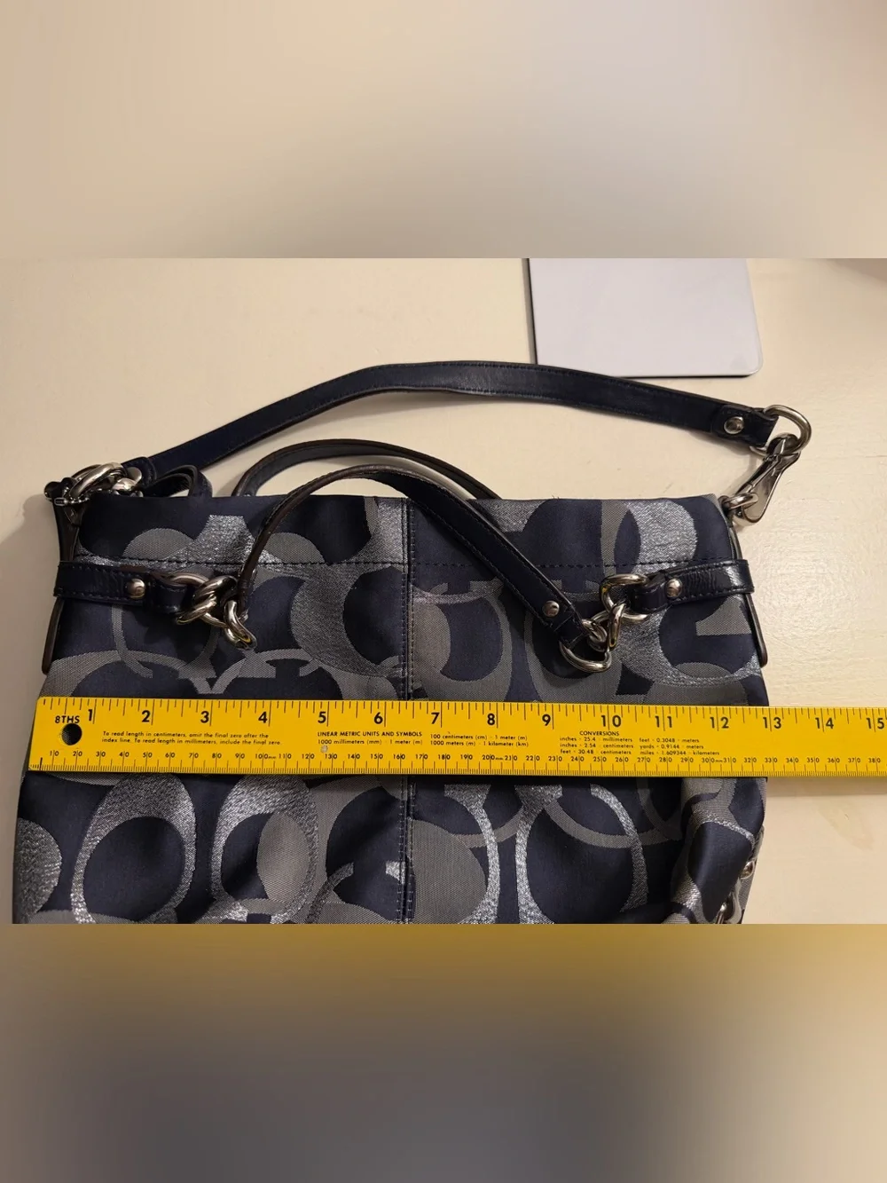 Coach navy , gray & metallic silver signature jacquard with navy leather trim.
